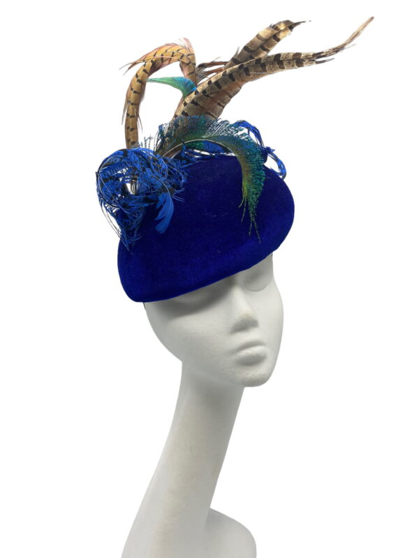 Blue velvet teardrop headpiece, finished with an array of coloured feathers.